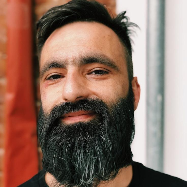 Aanya Kapoor, Lead Design Curator at PleasantNoteValley, reviewing corporate floral arrangements